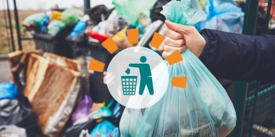 Person Holding Blue Trash Bag in Front of Piles of Garbage