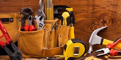 Various construction tools sit on a table.