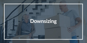 Downsizing text overlaid on an image of an older couple packing up boxes