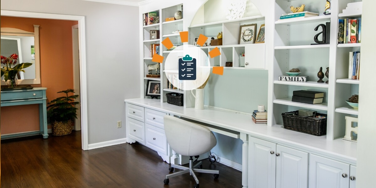 An organized and decluttered desk area featuring a wall-length white desk with white shelving to the ceiling and under cabinets and drawers.