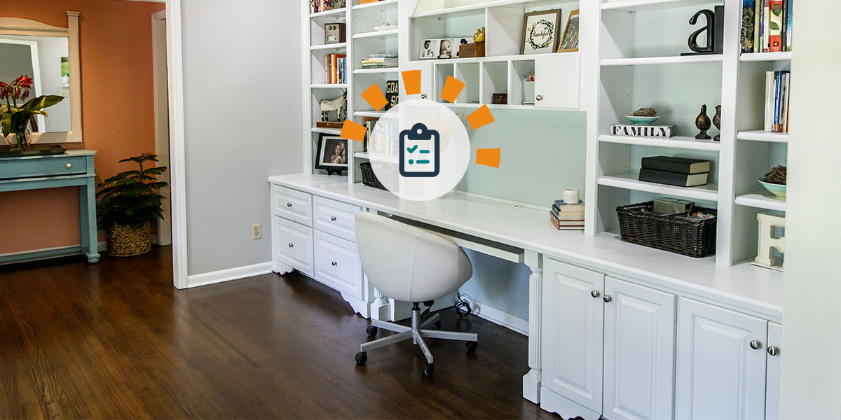 An organized and decluttered desk area featuring a wall-length white desk with white shelving to the ceiling and under cabinets and drawers.