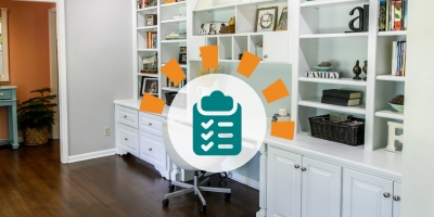An organized and decluttered desk area featuring a wall-length white desk with white shelving to the ceiling and under cabinets and drawers.