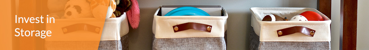 Six storage bins holding kids toys under a table.