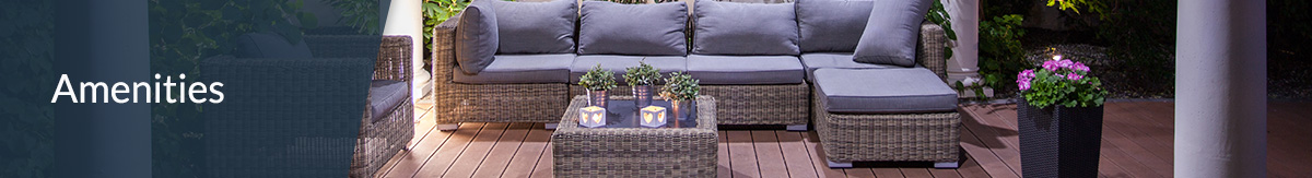 Outdoor patio-deck wicker sectional sofa with grey cushions and matching coffee table at night.