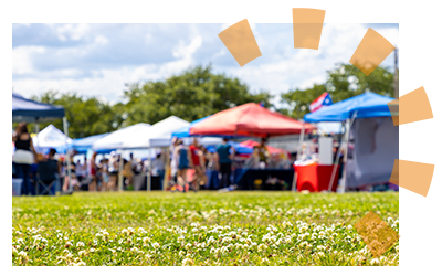 A large group of vendors at an outdoor event. 