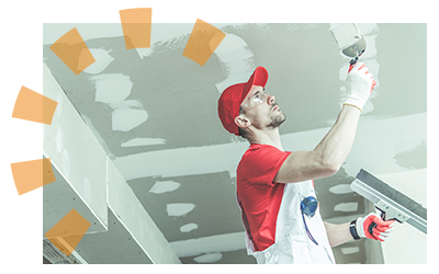 Man in red uniform repairing ceiling after removing wall.