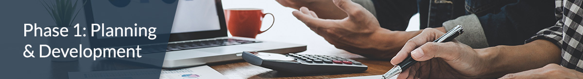 Phase 1: planning and development banner image that shows two people looking at reports at a desk.