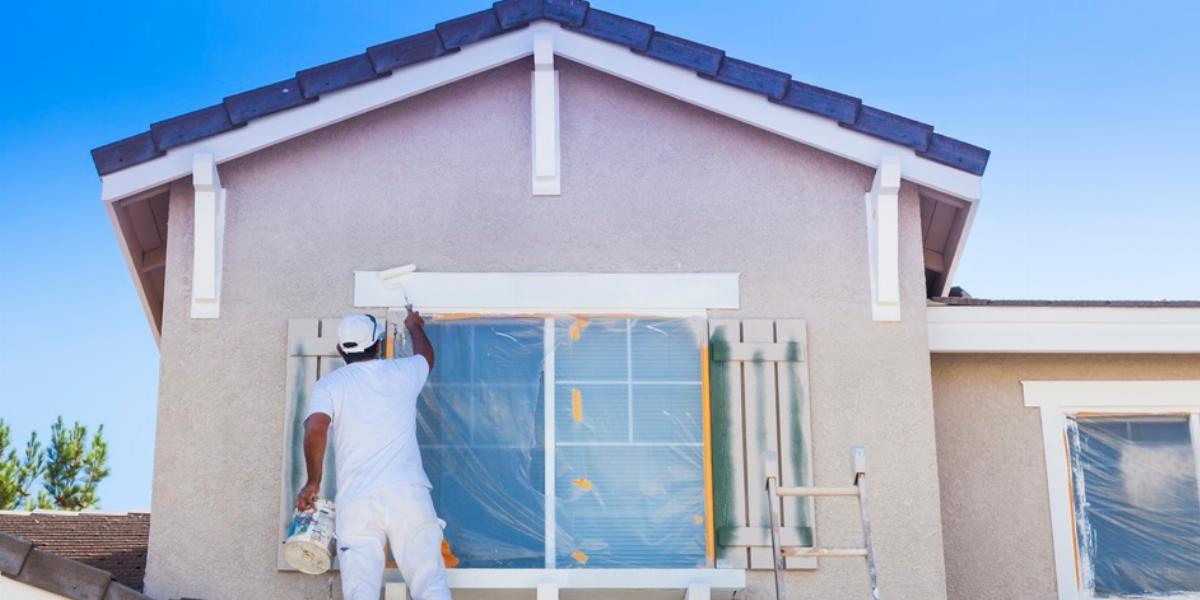 Man Painting Home Exterior.