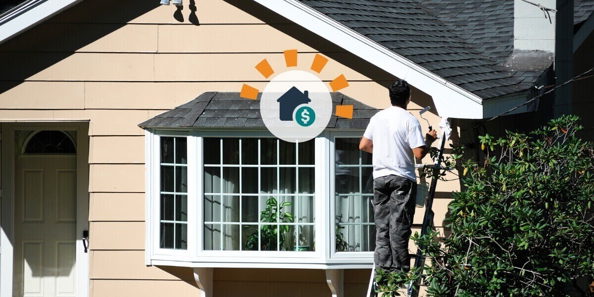 Homeowner prepping house for sale painting exterior.