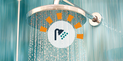 Closeup view of a newly installed rainfall showerhead after an old shower tearout.