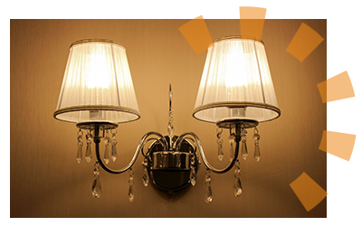 An antique sconce hanging on a wall.