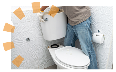 A man lifts a toilet tank from the bowl.