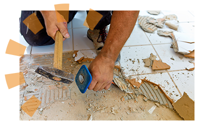 Homeowner using hammer and chisel to tear up floor tile.