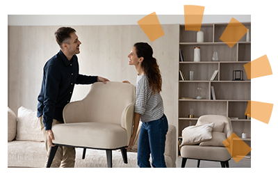 A man and woman remove furniture from a room.