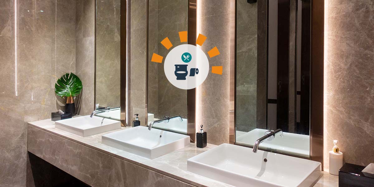 A marble bathroom counter with three ceramic sinks and mirrors.