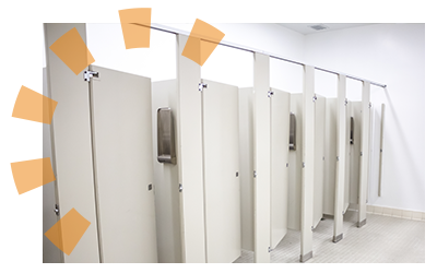 A row of toilet stalls in a commercial bathroom.