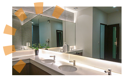 A commercial bathroom featuring multiple sink-to-ceiling mirrors.