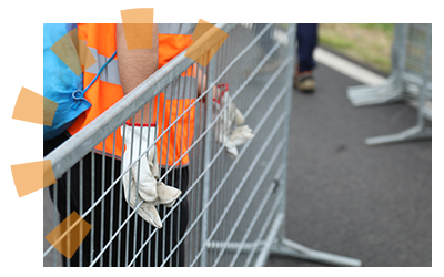 A volunteer creating restricted areas for an outdoor event.