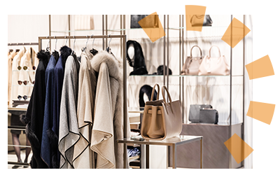 Coats and purses on display immediately after entering a retail store.