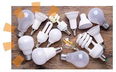 A variety of lightbulb types in a pile.