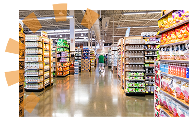 A wide main walkway leads to smaller isles in a grocery store.