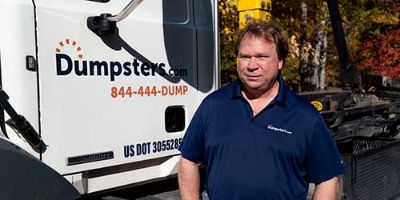 COO of Cleveland Hauling Operations Rich Gersdorf Standing Next to a Dumpsters.com Truck.