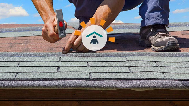 Man nailing shingles on roof