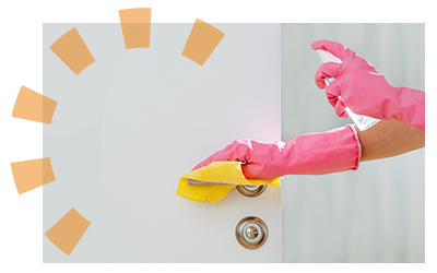 A person in pink rubber gloves cleaning a door handle. 