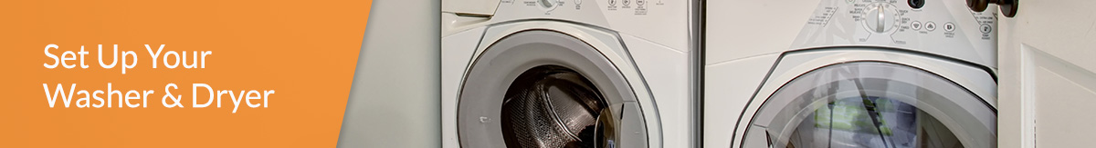 Front loading washer and dryer next to cabinetry. 