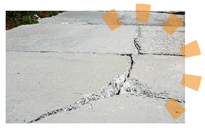 Close-up of a broken, cracked concrete slab.