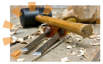 Sledge hammer sitting on wood carving tools used to pound joists loose for removal.