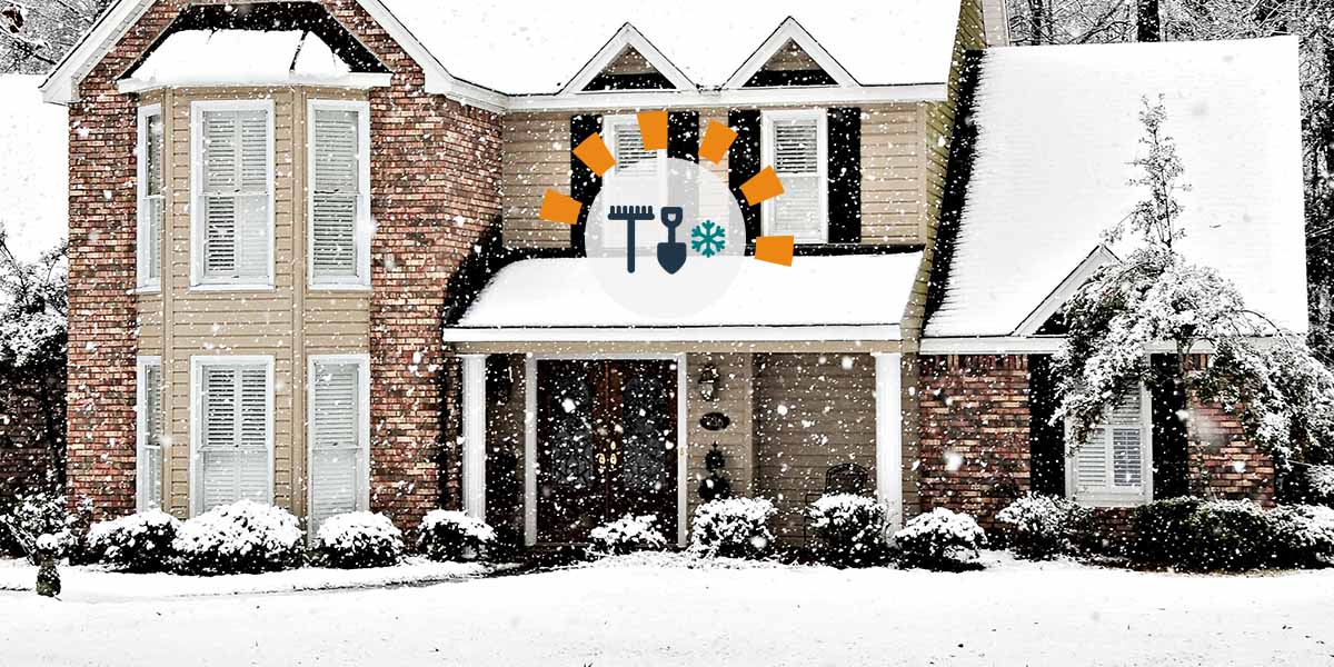 A two-story house covered in snow with the Dumpsters.com orange radial arc logo in the center of the image.
