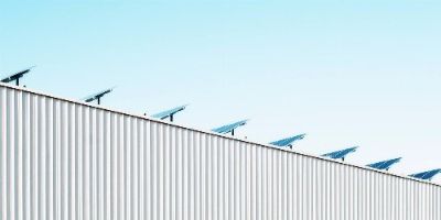 The side profile of a building with solar panels situated on the roof.