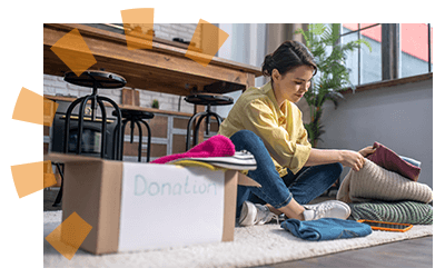 A woman sitting in her old home decluttering items to downsize into a new home. 