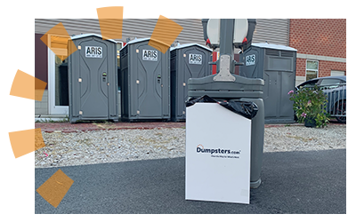 A Dumpsters.com trash can located by a portable sanitation station.