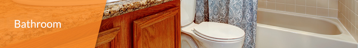 A standard bathroom with wood cabinet vanity, toilet and shower/bathtub combo.
