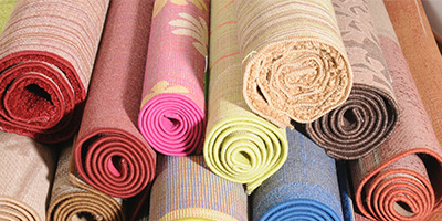 Stacked rolls of old colored carpet.