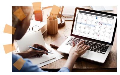A person on a laptop working on constructing a schedule.