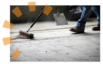 A man sweeping his garage after organizing it.