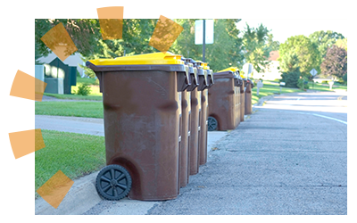 Curbside garbage collection cans sitting in the street.