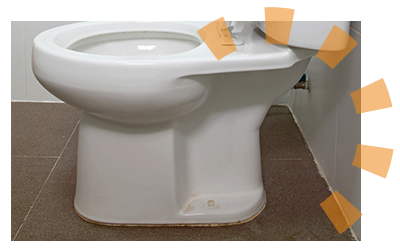 A toilet fastened to the floor with a floor bolt.
