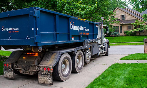 Roll Off Dumpster on Truck in Driveway.