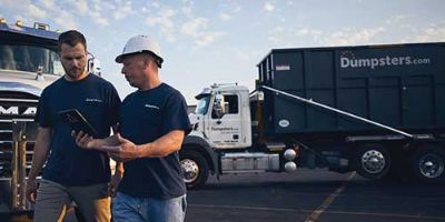 Two men with dumpster trucks.