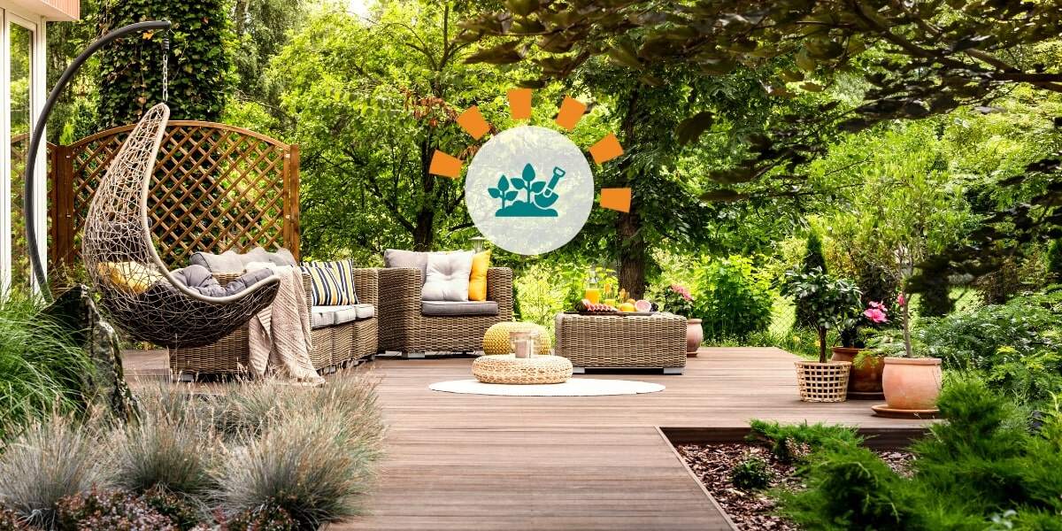 Updated backyard with wooden terrace, garden with potted flowers and wicker swing chair. 