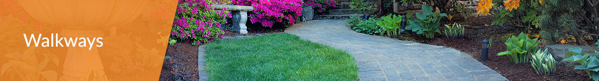 The header "landscaping" over the photo of a stone walkway in updated backyard with garden, flowers and stone fountain and bench on either side.