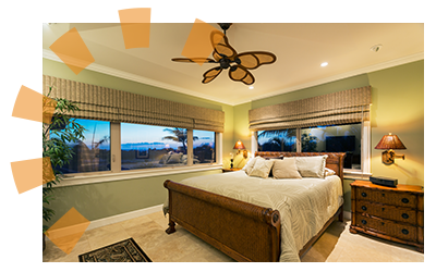 A bedroom with green walls and wicker bedframe