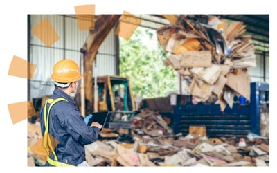 Worker at Material Recovery Facility Sorting Cardboard