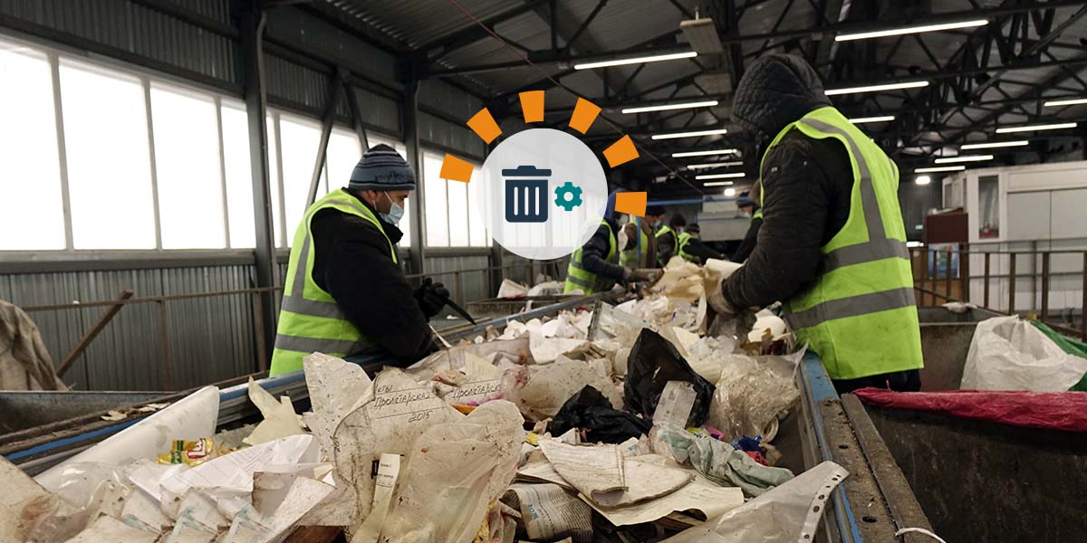 Waste processing plant workers sorting trash
