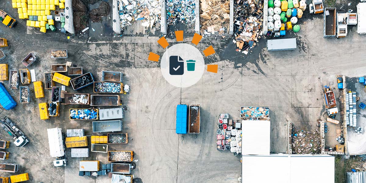 Aerial image of a waste sorting site with truck trailers filled with sorted debris.