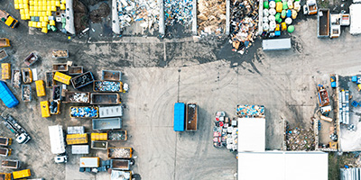 An aerial shot of an outdoor recycling center with waste sorted by type.